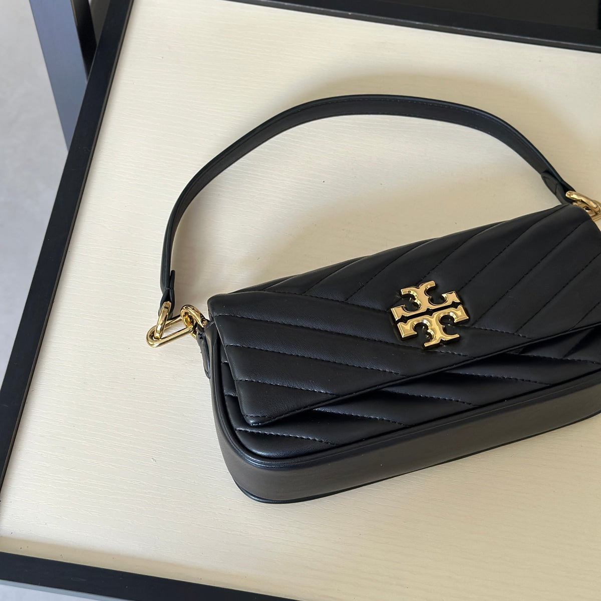 THE KIRA CHEVRON SMALL FLAP SHOULDER BAG - BLACK